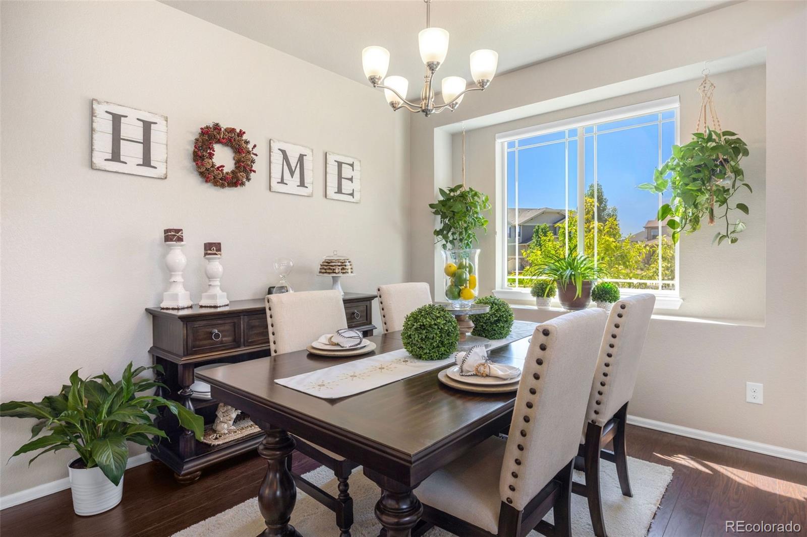 8809 Foxfire Street Firestone, CO 80504 - Photo 6 of 32 a view of a dining room with furniture window and wooden floor