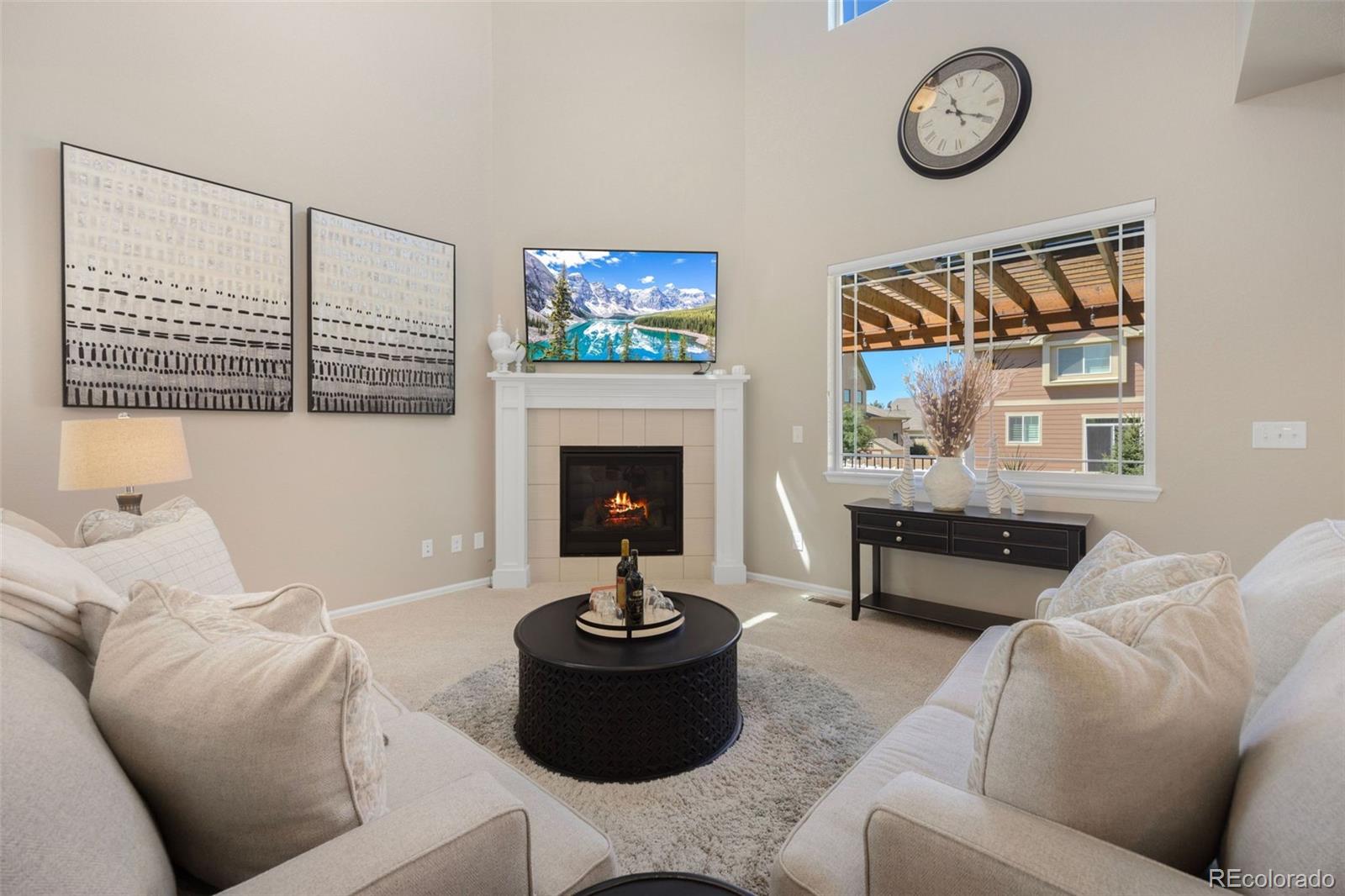 8809 Foxfire Street Firestone, CO 80504 - Photo 7 of 32 a living room with furniture a fireplace and a large window