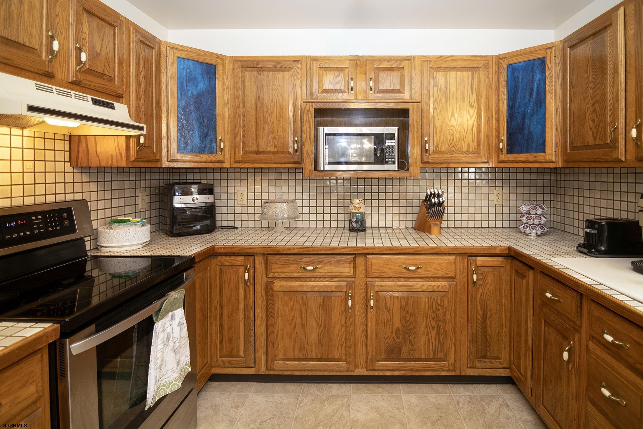55 Taylor Avenue Milmay, NJ 08340 - Photo 15 of 53 a kitchen with stainless steel appliances a sink stove and cabinets
