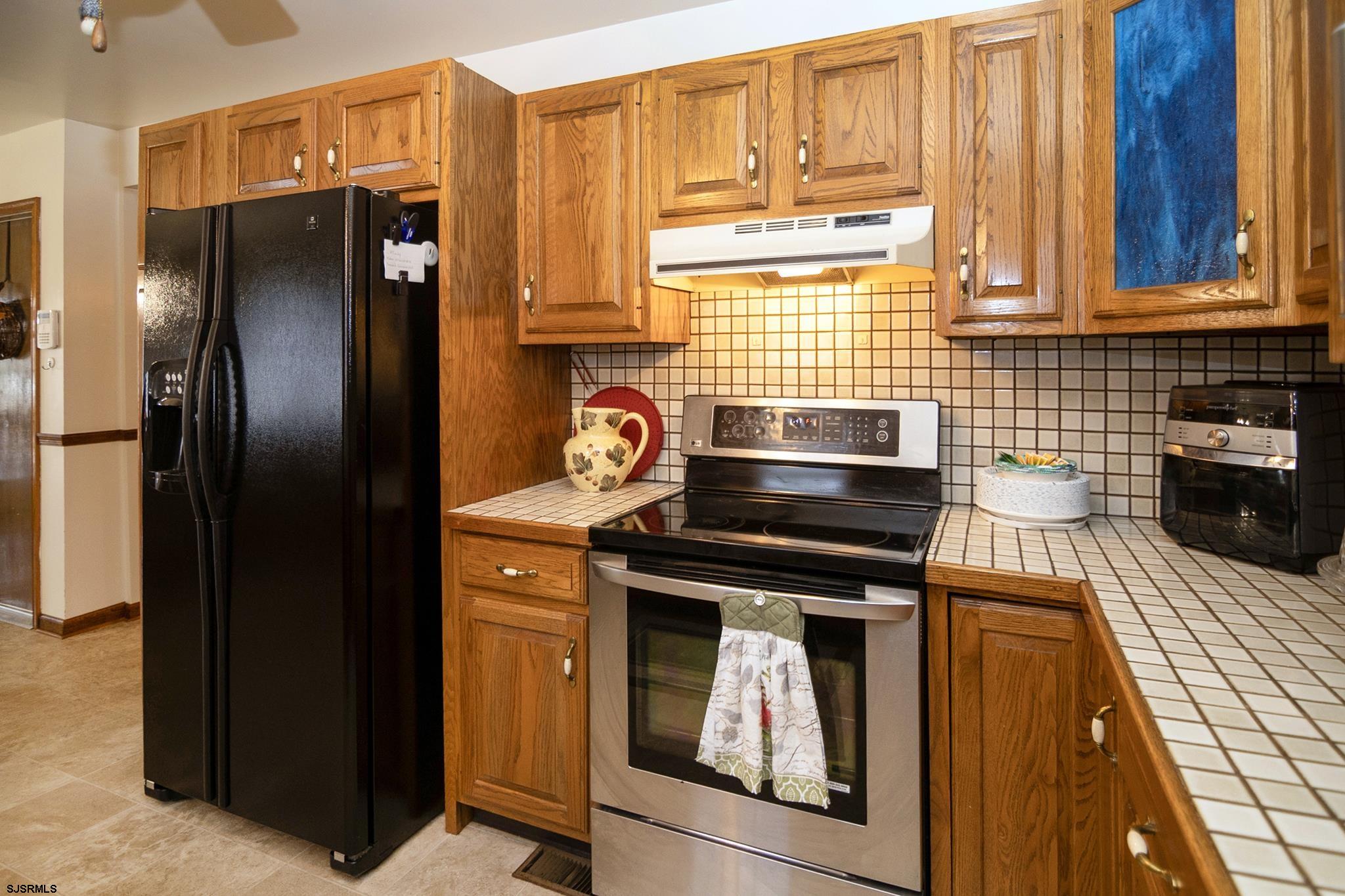 55 Taylor Avenue Milmay, NJ 08340 - Photo 17 of 53 a kitchen with stainless steel appliances granite countertop a refrigerator and a stove top oven