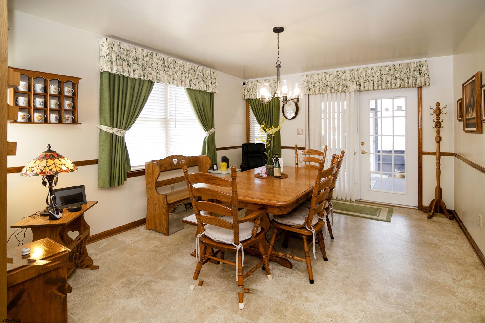 55 Taylor Avenue Milmay, NJ 08340 - Photo 18 of 53 a dining room with furniture a chandelier and window