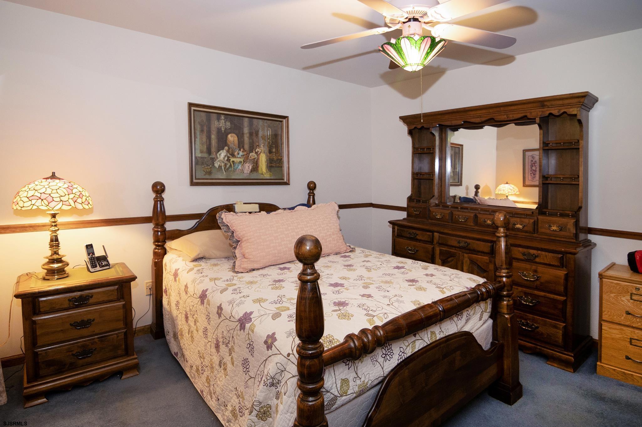 55 Taylor Avenue Milmay, NJ 08340 - Photo 22 of 53 a bedroom with a bed and a chandelier