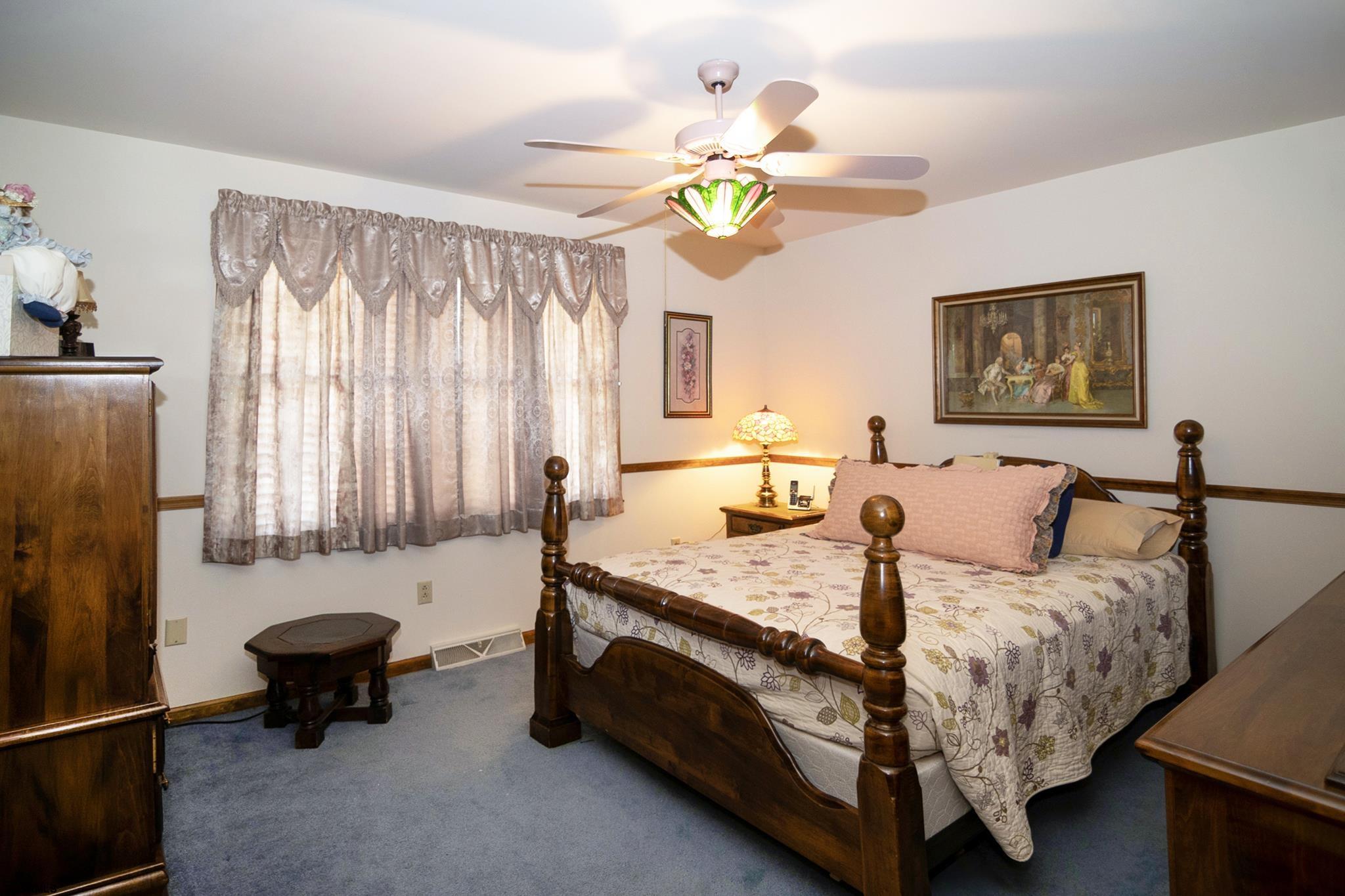 55 Taylor Avenue Milmay, NJ 08340 - Photo 24 of 53 a bed room with a bed and a chandelier