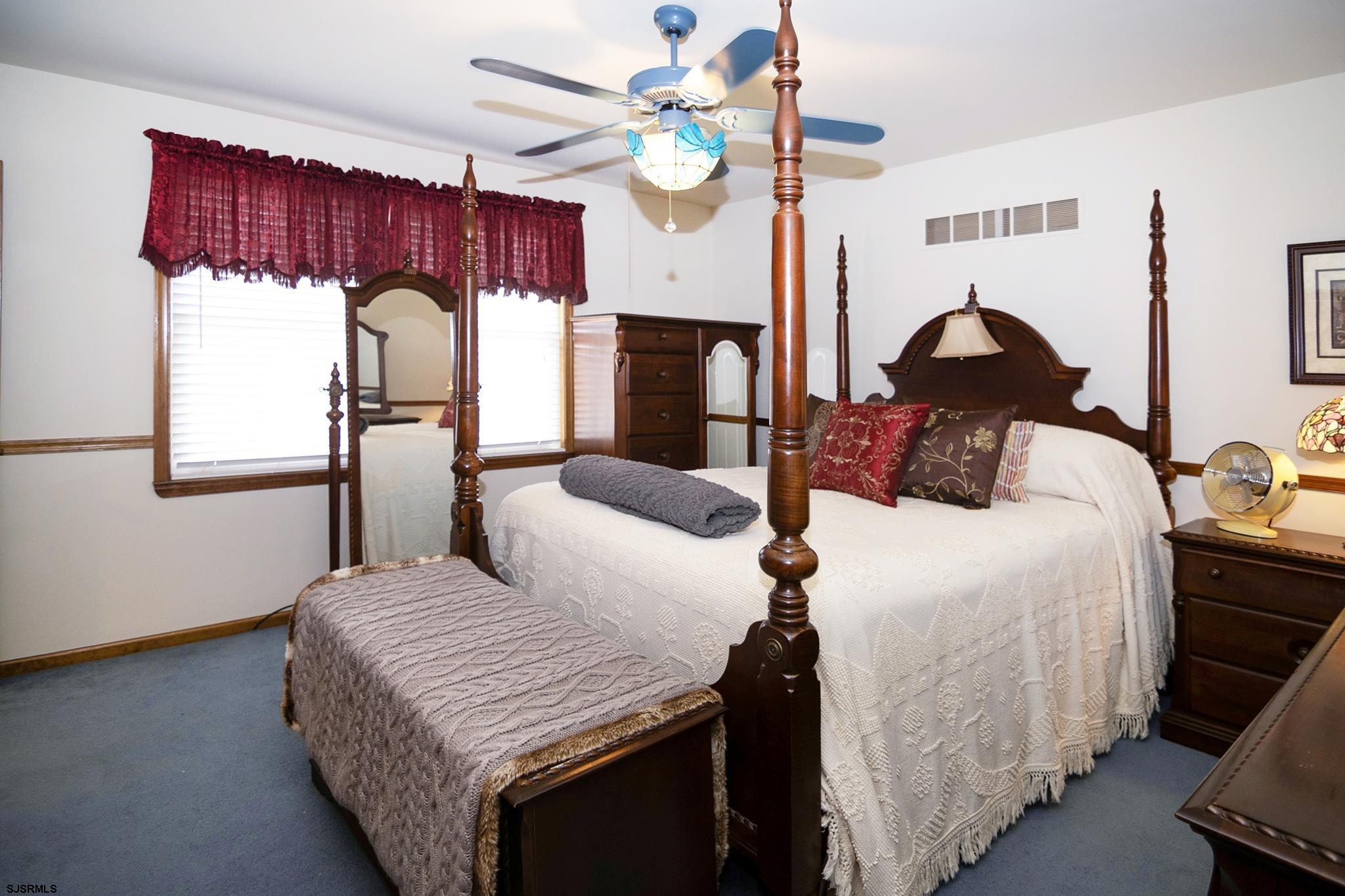 55 Taylor Avenue Milmay, NJ 08340 - Photo 25 of 53 a bedroom with a bed a dresser and potted plants