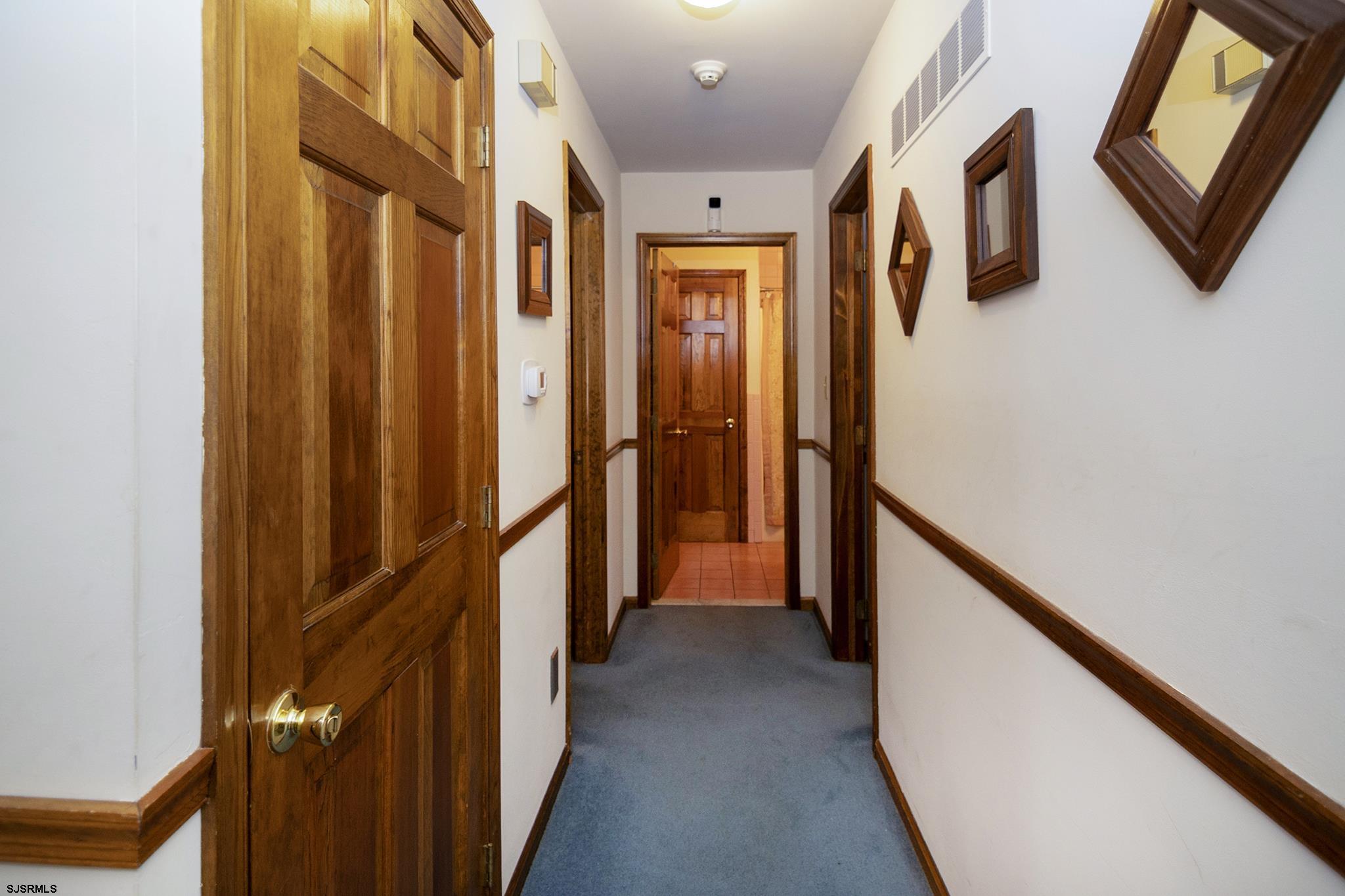 55 Taylor Avenue Milmay, NJ 08340 - Photo 30 of 53 a view of a hallway with wooden floor and staircase