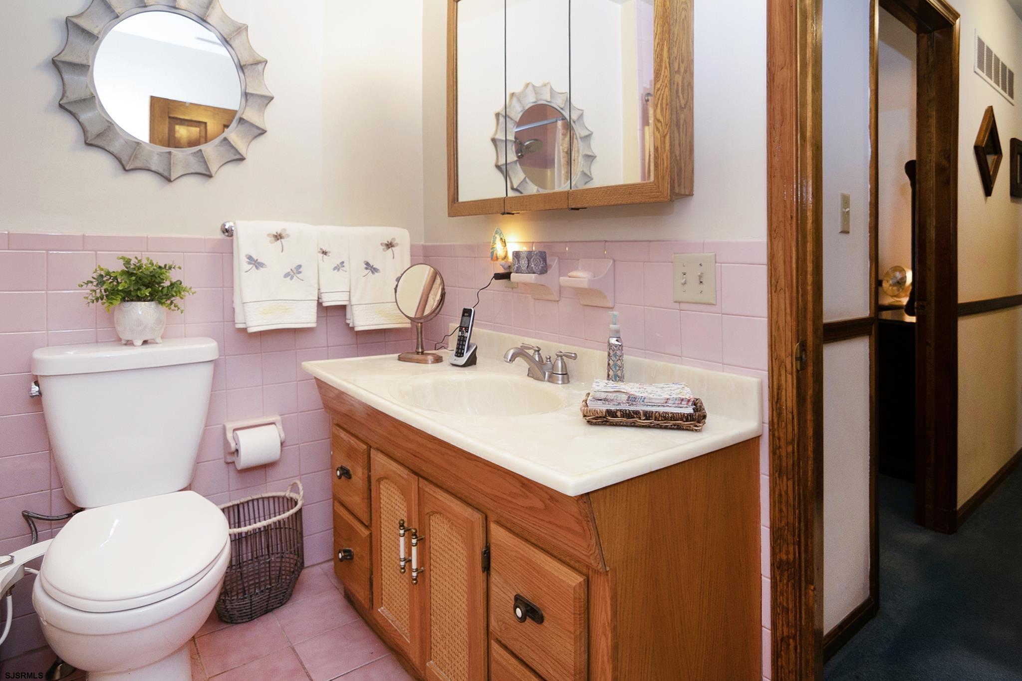 55 Taylor Avenue Milmay, NJ 08340 - Photo 33 of 53 a bathroom with a sink a toilet and a mirror