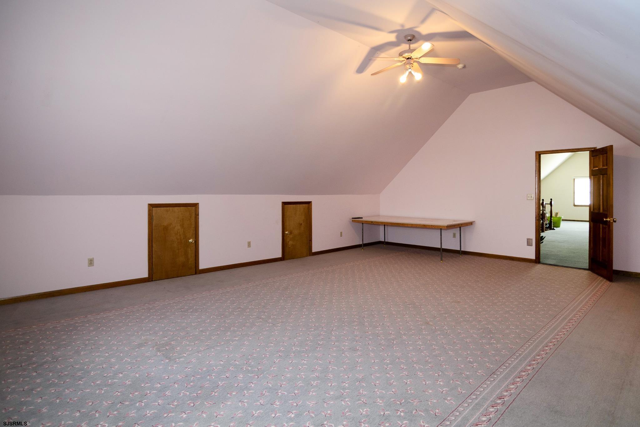 55 Taylor Avenue Milmay, NJ 08340 - Photo 39 of 53 an empty room with chandelier fan and windows