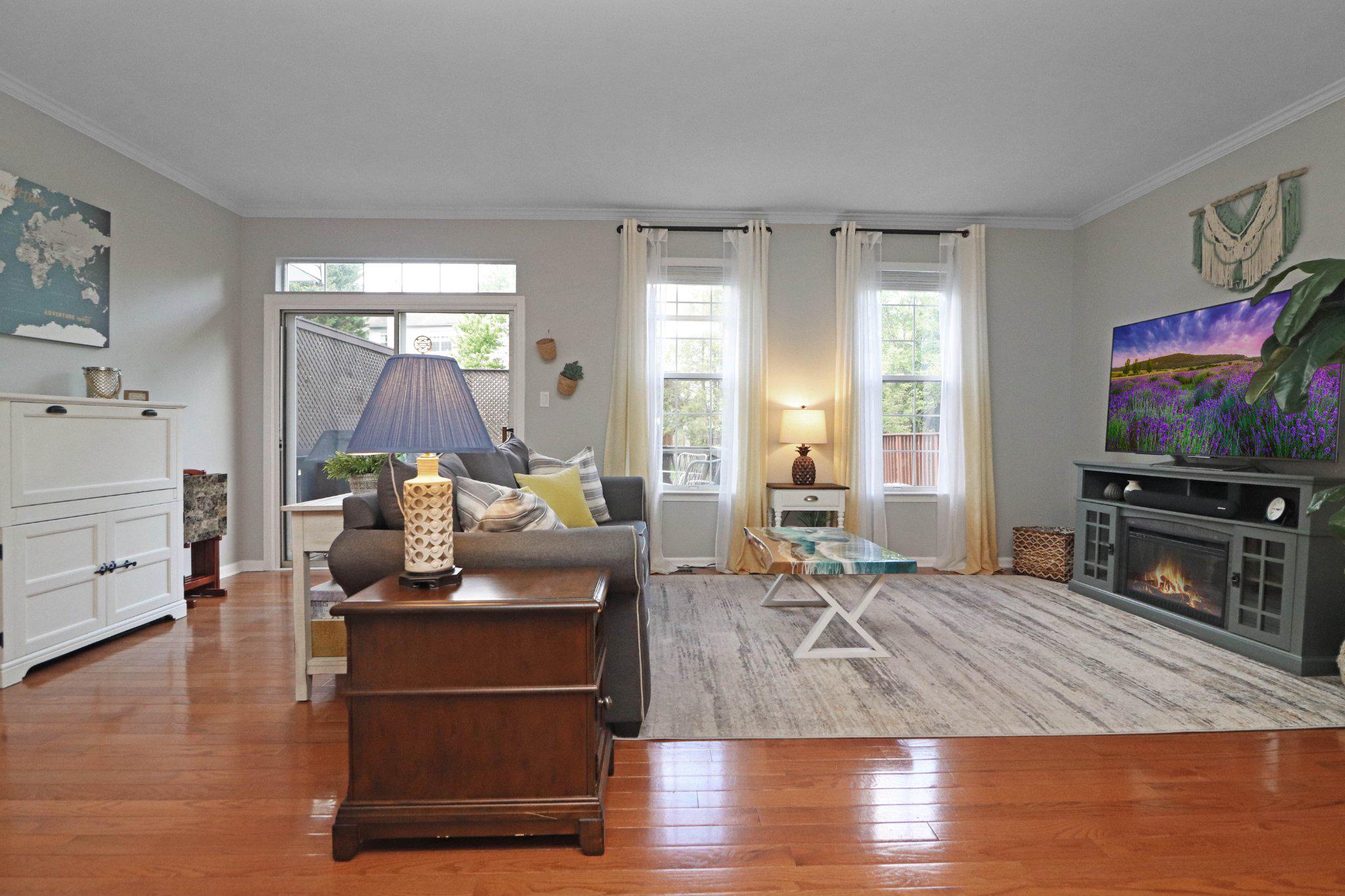 47640 Comer Square Sterling, VA 20165 - Photo 17 of 58 a living room with furniture a flat screen tv and a fireplace