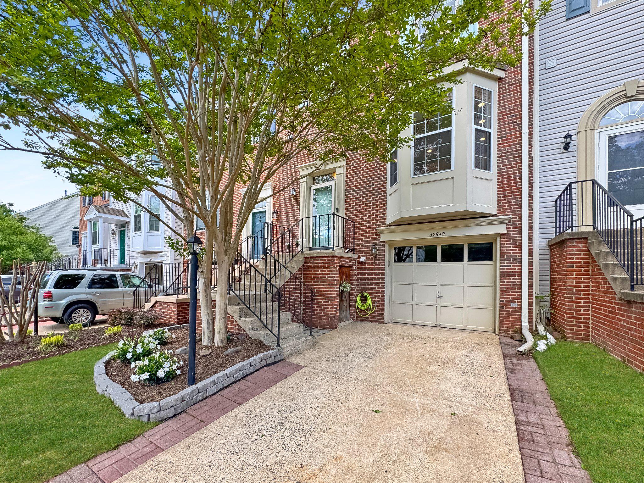 47640 Comer Square Sterling, VA 20165 - Photo 3 of 58 a front view of a house with garden