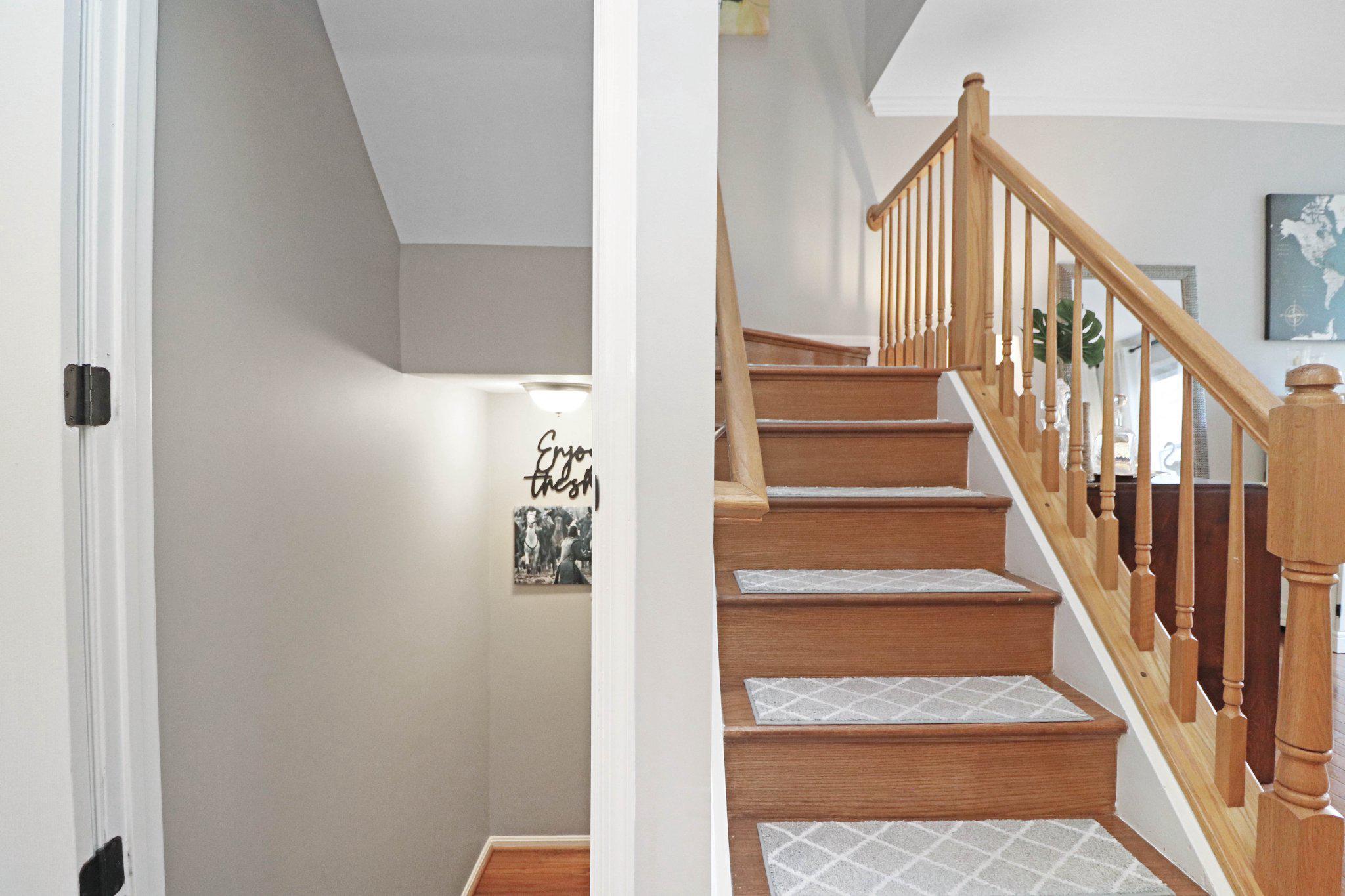 47640 Comer Square Sterling, VA 20165 - Photo 31 of 58 a view of staircase with wooden floor and lots of frames on wall