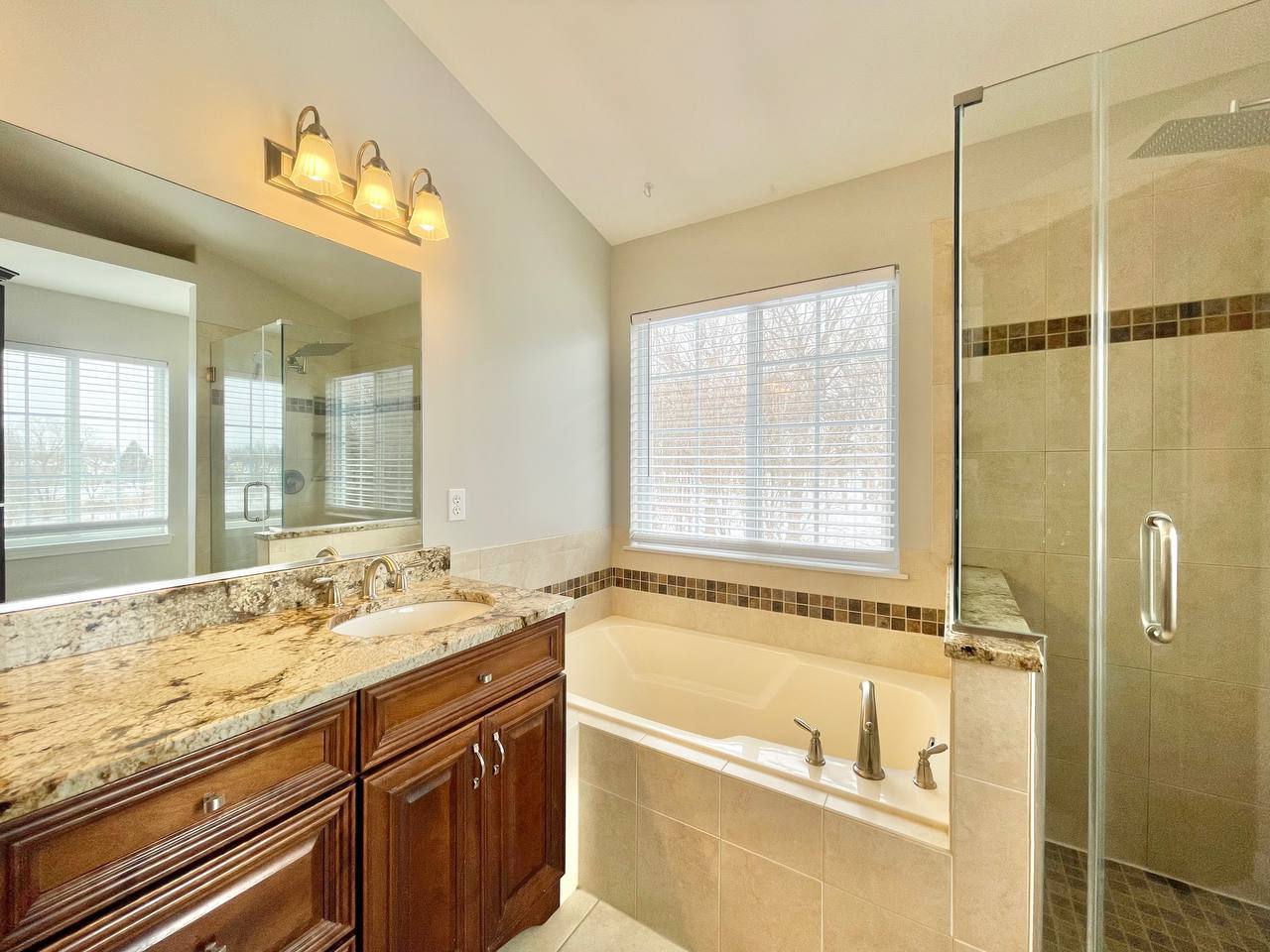 602 Pearces Ford Road Oswego, IL 60543 - Photo 16 of 40 a bathroom with a granite countertop tub sink and mirror