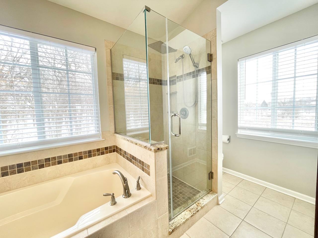 602 Pearces Ford Road Oswego, IL 60543 - Photo 17 of 40 a bathroom with a bathtub and a shower