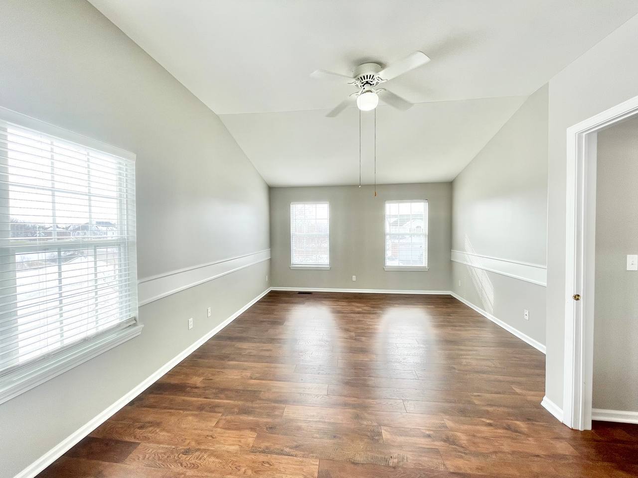 602 Pearces Ford Road Oswego, IL 60543 - Photo 19 of 40 a view of an empty room with wooden floor and a window