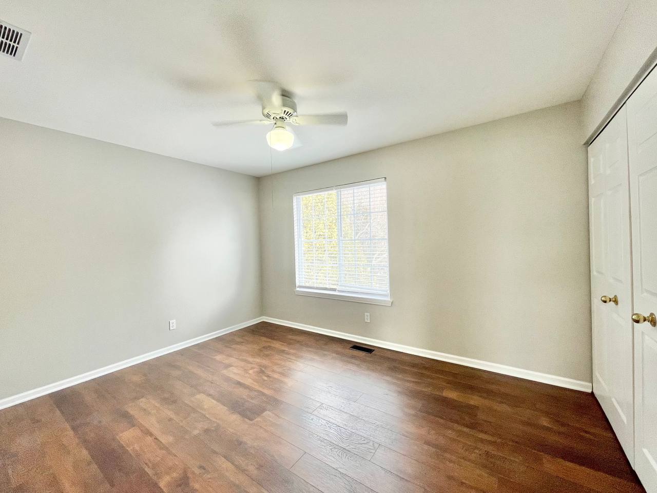 602 Pearces Ford Road Oswego, IL 60543 - Photo 27 of 40 an empty room with wooden floor fan and windows