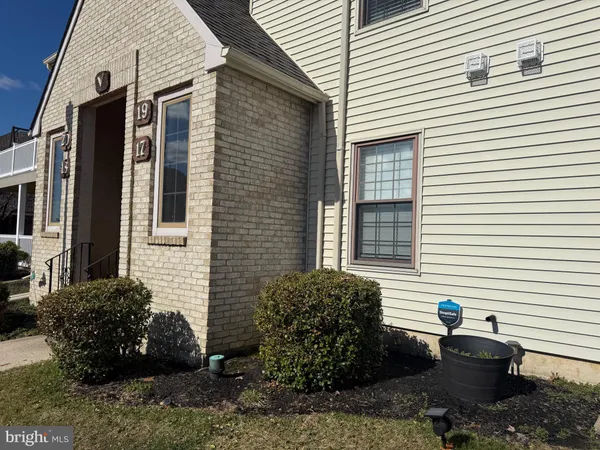 a view of a house with a yard and a patio