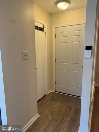 an empty room with wooden floor and closet