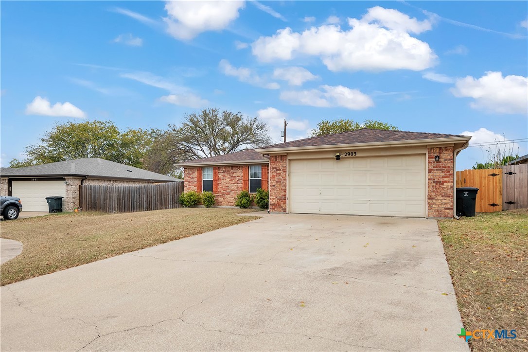 2903 Blue Ridge Drive Killeen, TX 76543 - Photo 1 of 32 a front view of a house with a yard and garage