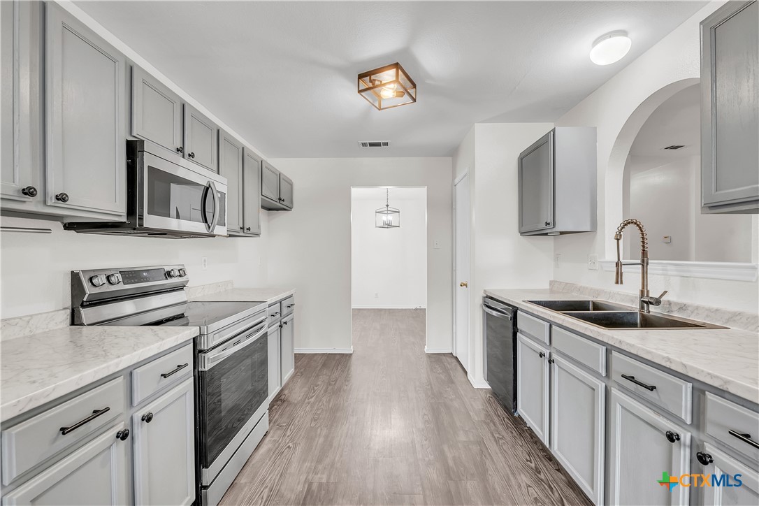 2903 Blue Ridge Drive Killeen, TX 76543 - Photo 13 of 32 a kitchen with stainless steel appliances granite countertop a sink stove and cabinets