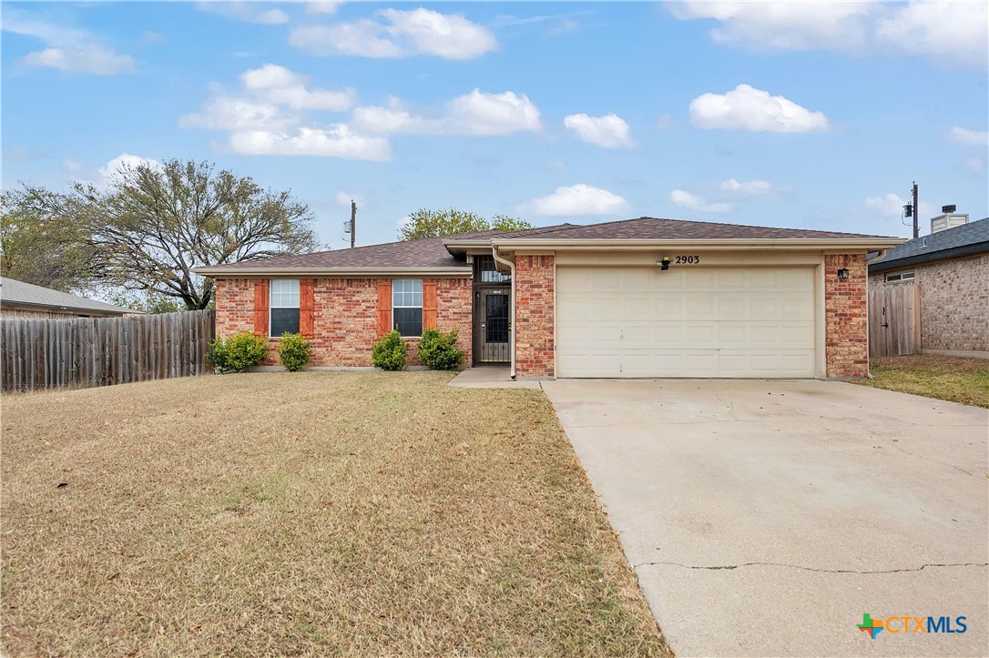 2903 Blue Ridge Drive Killeen, TX 76543 - Photo 2 of 32 a front view of a house with a yard and garage