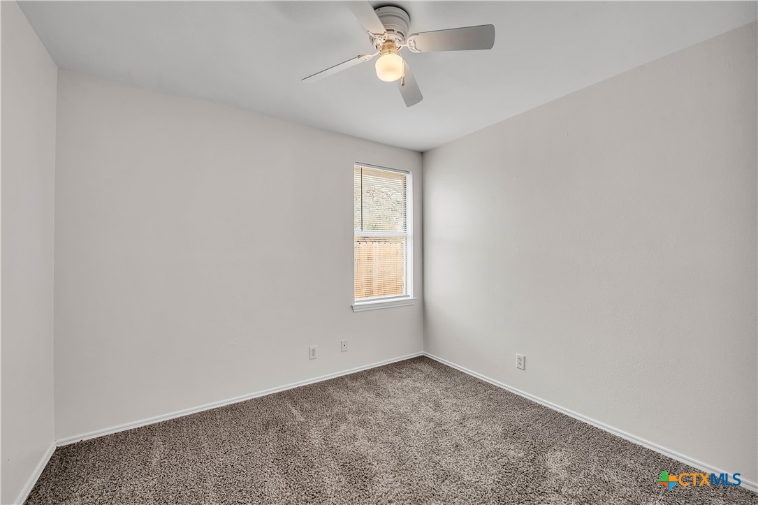 2903 Blue Ridge Drive Killeen, TX 76543 - Photo 27 of 32 an empty room with a chandelier fan and windows