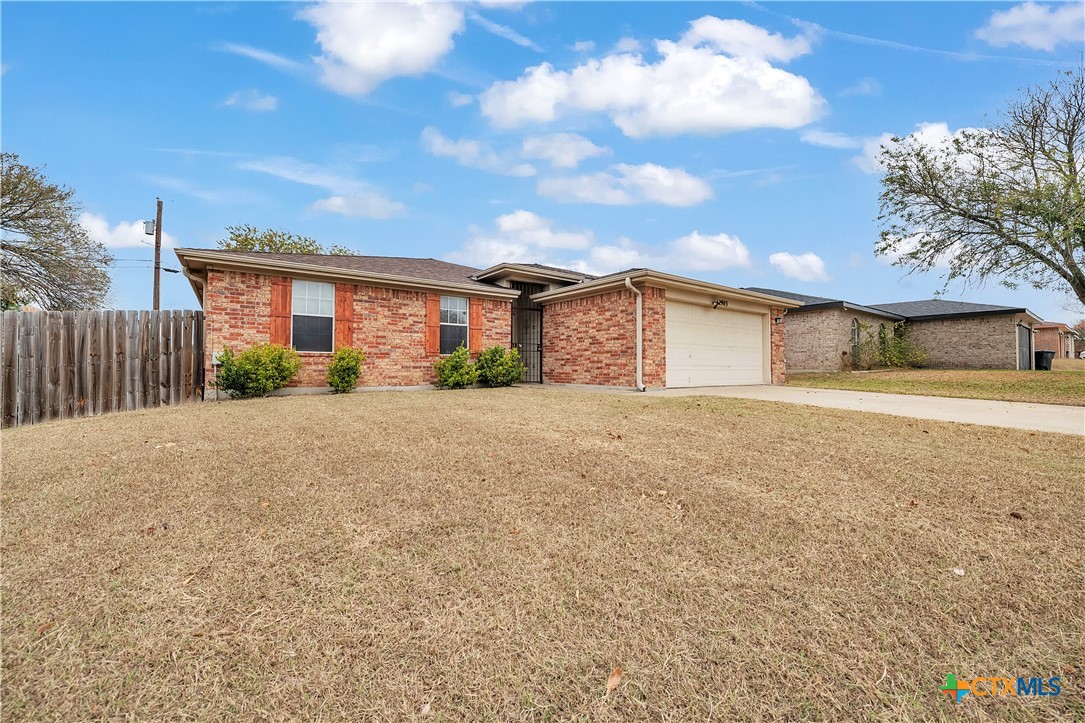 2903 Blue Ridge Drive Killeen, TX 76543 - Photo 4 of 32 a front view of a house with a yard and garage