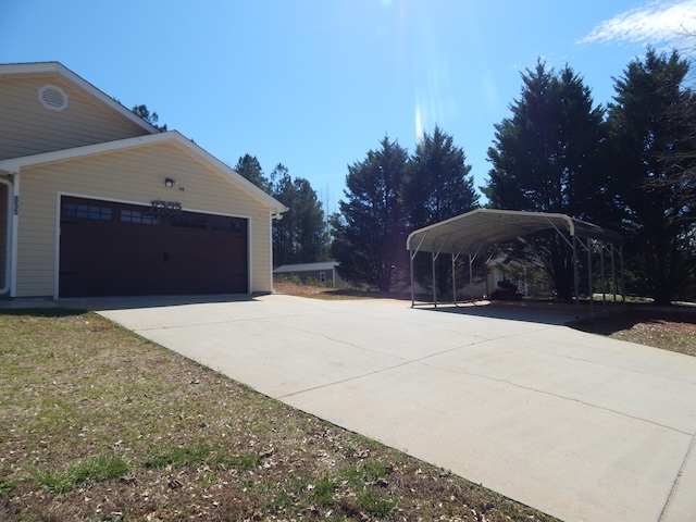 855 Louie Lane Seneca, SC 29678 - Photo 2 of 33 This residence features a convenient attached garage and an additional carport for ample parking.