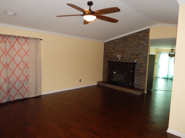 855 Louie Lane Seneca, SC 29678 - Photo 9 of 33 Warm hardwood floors and a stone-accented fireplace create a cozy living space.