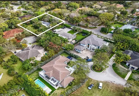 an aerial view of residential house with outdoor space and swimming pool