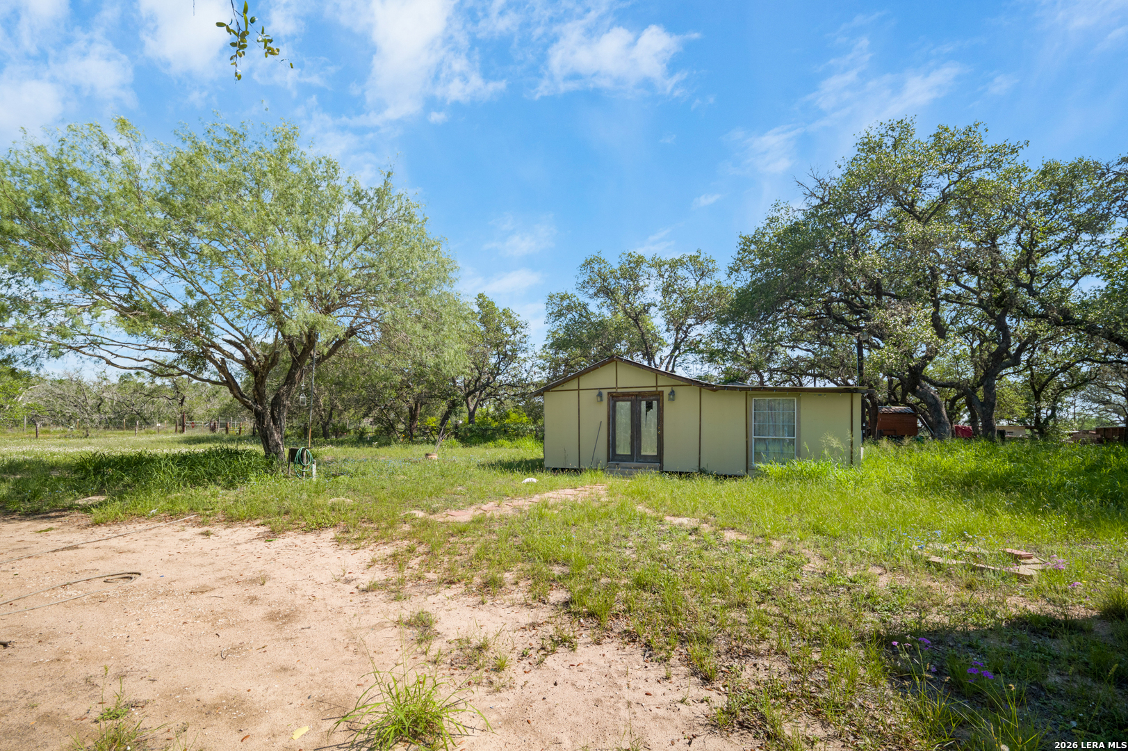 230 P R D65 Poteet, TX 78065 - Photo 4 of 29 a view of a back yard of the house