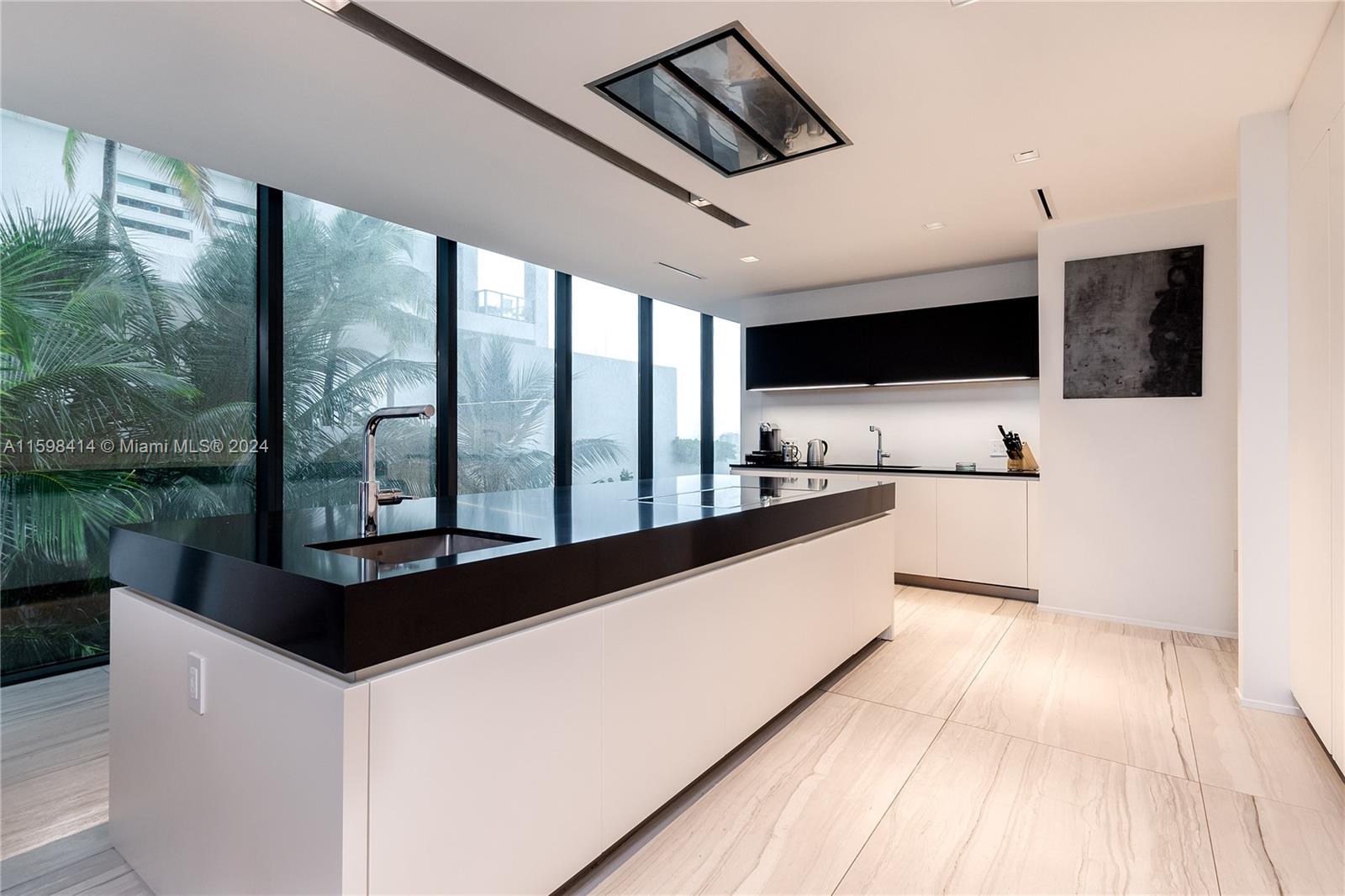 1000 Biscayne Boulevard, Unit TH1002 Miami, FL 33132 - Photo 18 of 27 a kitchen with kitchen island a large counter top space a sink and stainless steel appliances