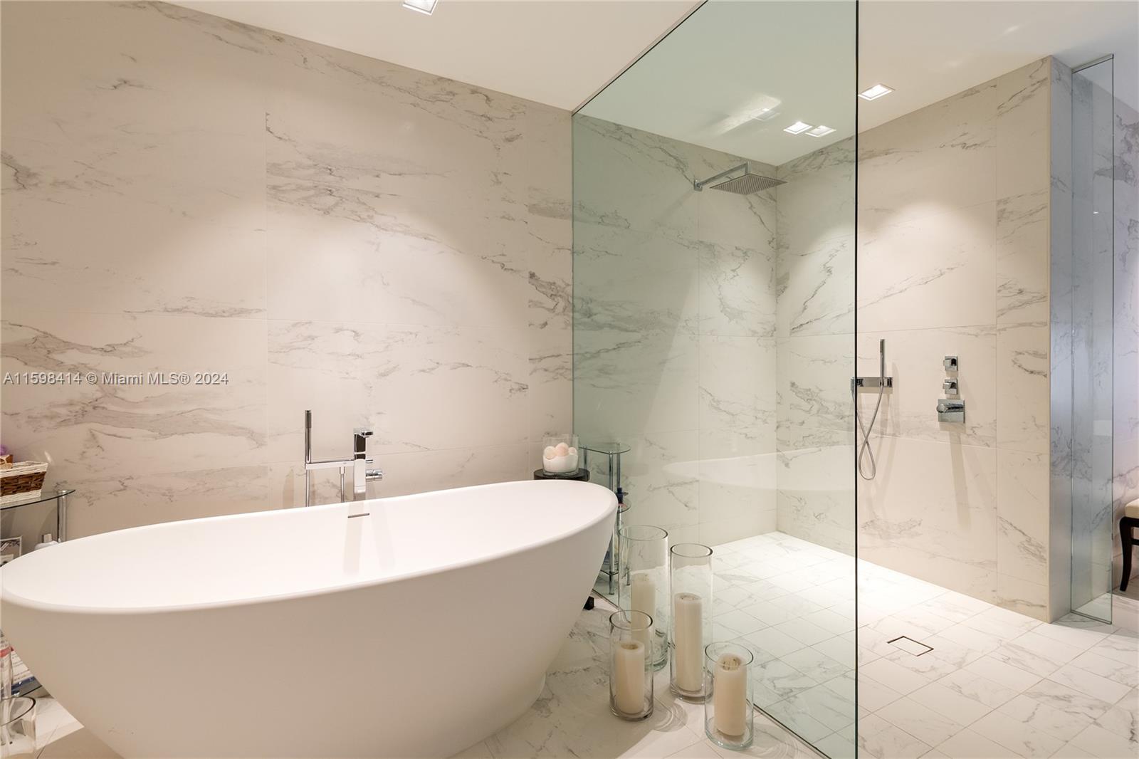 1000 Biscayne Boulevard, Unit TH1002 Miami, FL 33132 - Photo 22 of 27 a white bath tub sitting in a bathroom and a shower