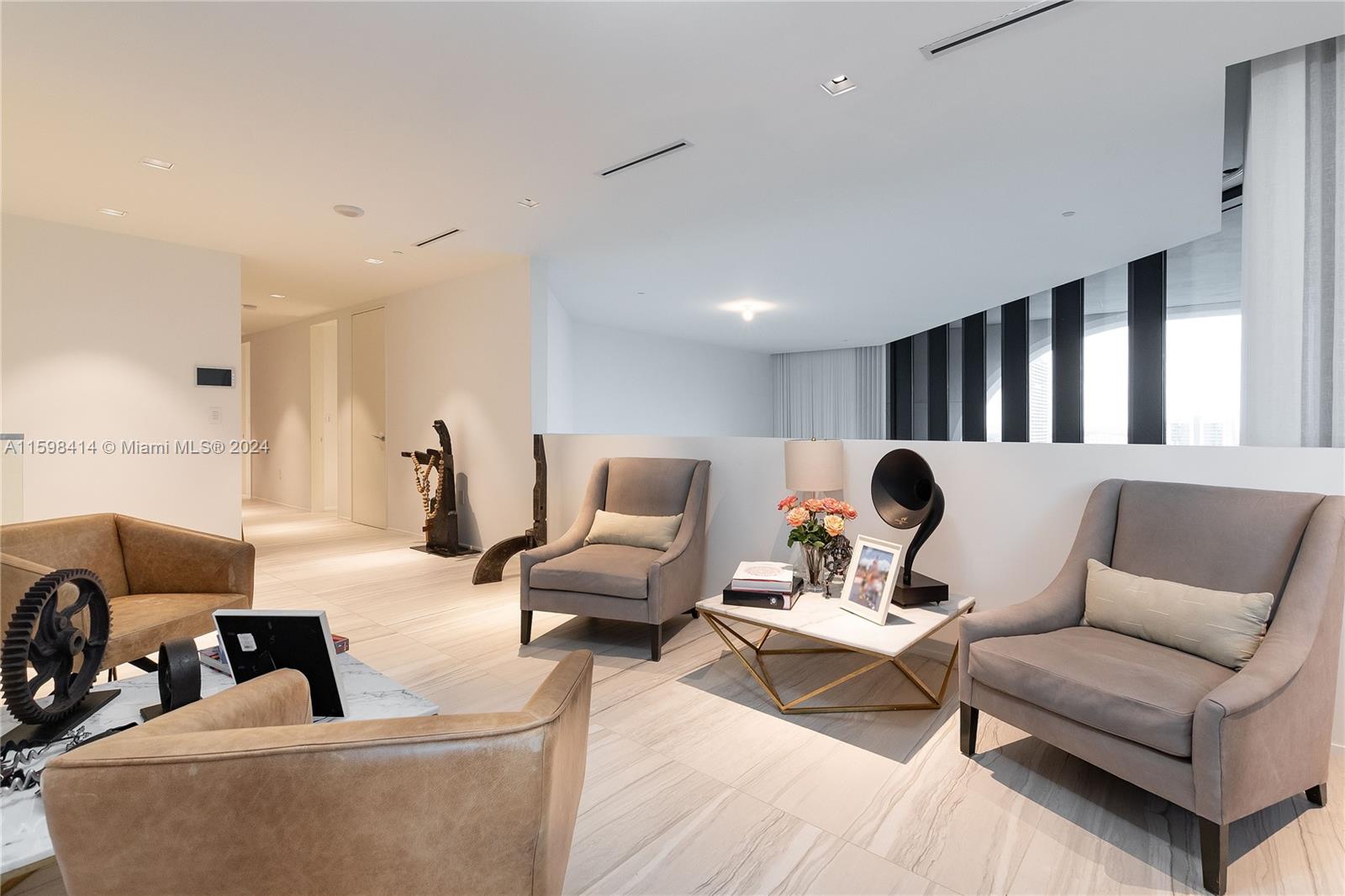 1000 Biscayne Boulevard, Unit TH1002 Miami, FL 33132 - Photo 26 of 27 a living room with furniture and a lamp