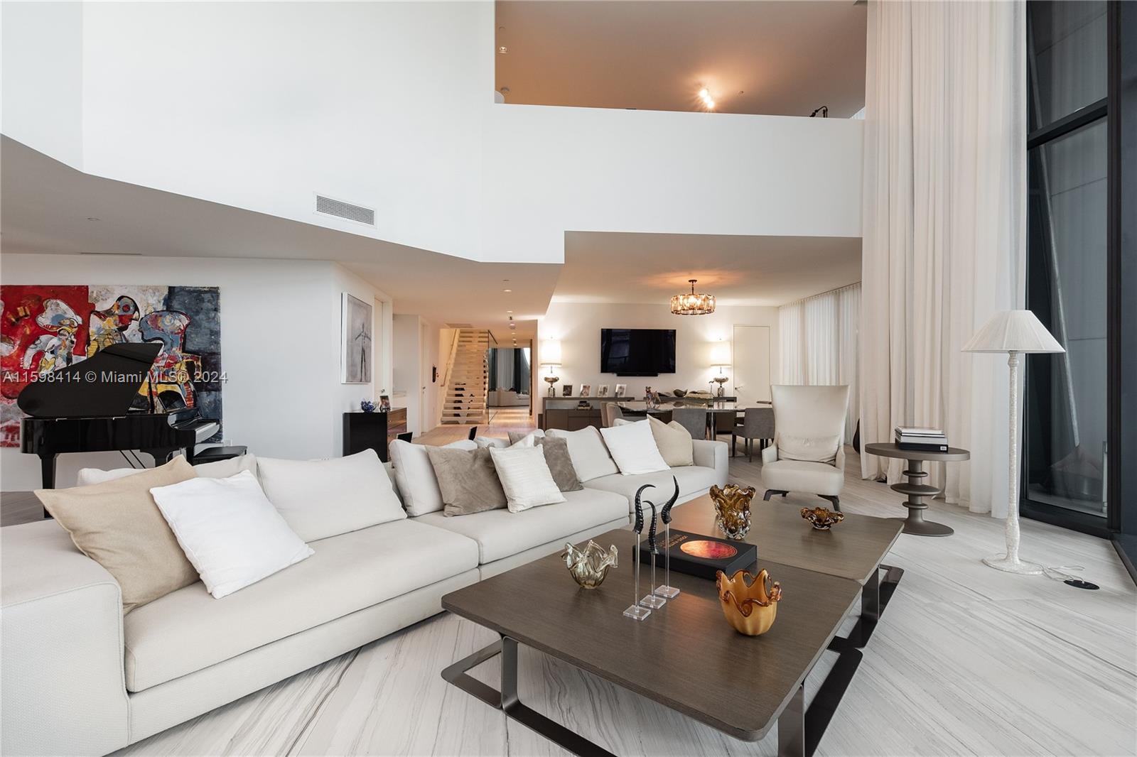 1000 Biscayne Boulevard, Unit TH1002 Miami, FL 33132 - Photo 6 of 27 a living room with furniture and a fireplace