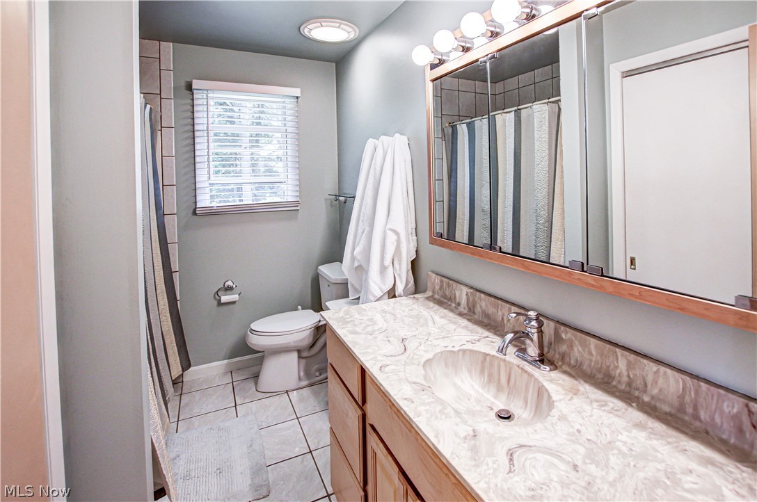 910 Andrews Road Medina, OH 44256 - Photo 30 of 45 Bathroom with tile floors, toilet, and vanity