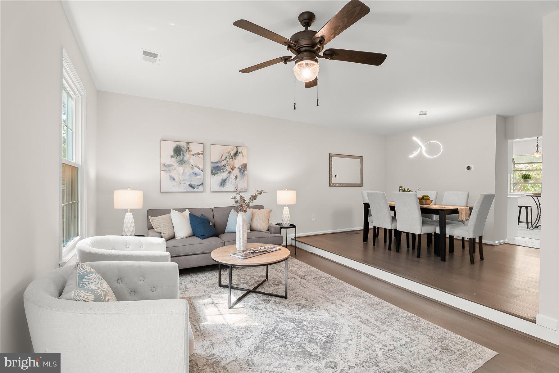 1530 Tanyard Hill Road Gaithersburg, MD 20879 - Photo 15 of 40 a living room with furniture a rug and a chandelier