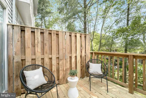 a view of a chair and table in the balcony