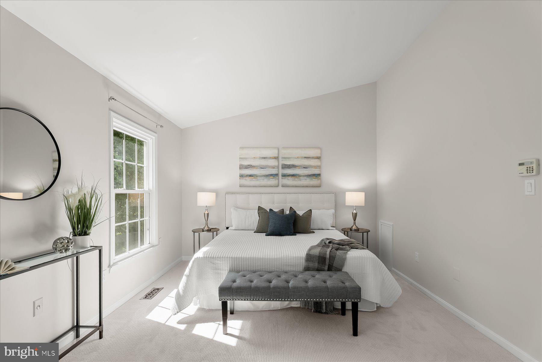 1530 Tanyard Hill Road Gaithersburg, MD 20879 - Photo 21 of 40 a bedroom with a bed a mirror and a large window