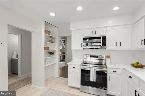a kitchen with stainless steel appliances granite countertop a stove and a refrigerator