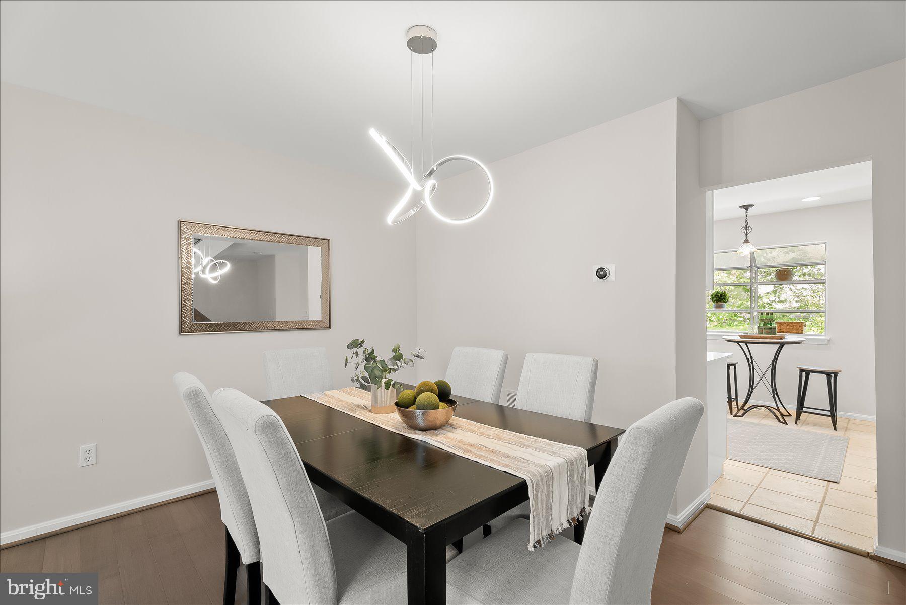 1530 Tanyard Hill Road Gaithersburg, MD 20879 - Photo 9 of 40 a view of a dining room with furniture and wooden floor