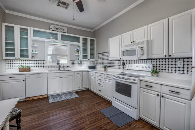a kitchen with a sink stove and cabinets
