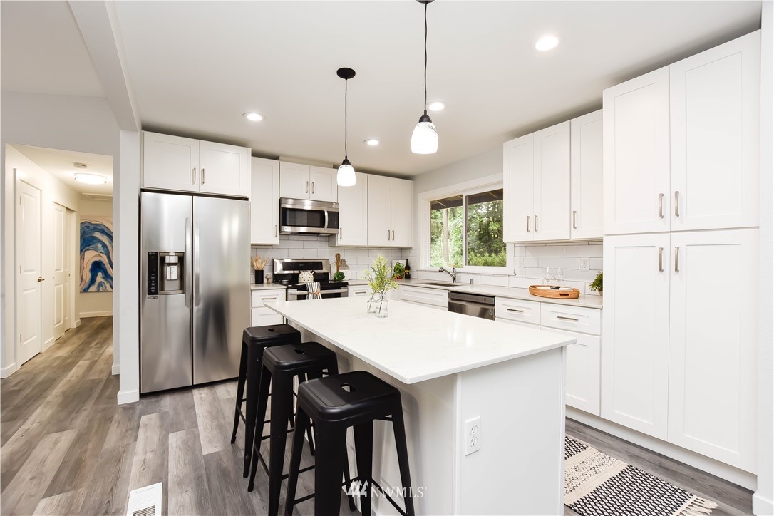 322 170th Place Southwest Bothell, WA 98012 - Photo 12 of 37 a kitchen with refrigerator cabinets and wooden floor