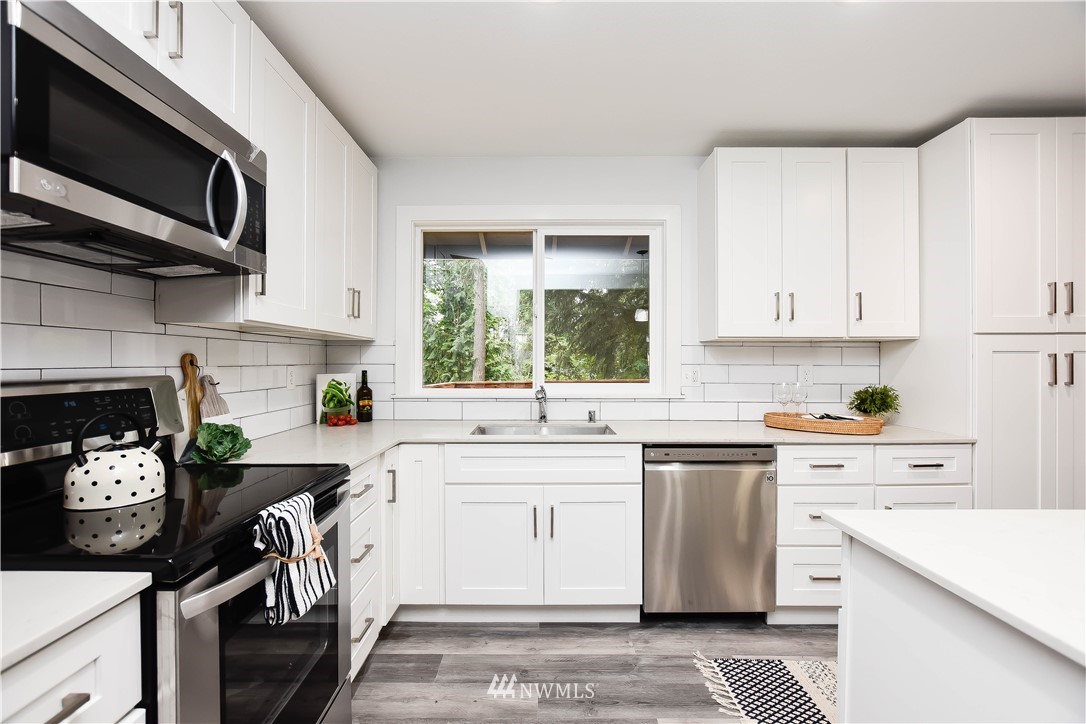 322 170th Place Southwest Bothell, WA 98012 - Photo 14 of 37 a kitchen with a stove a sink and a microwave