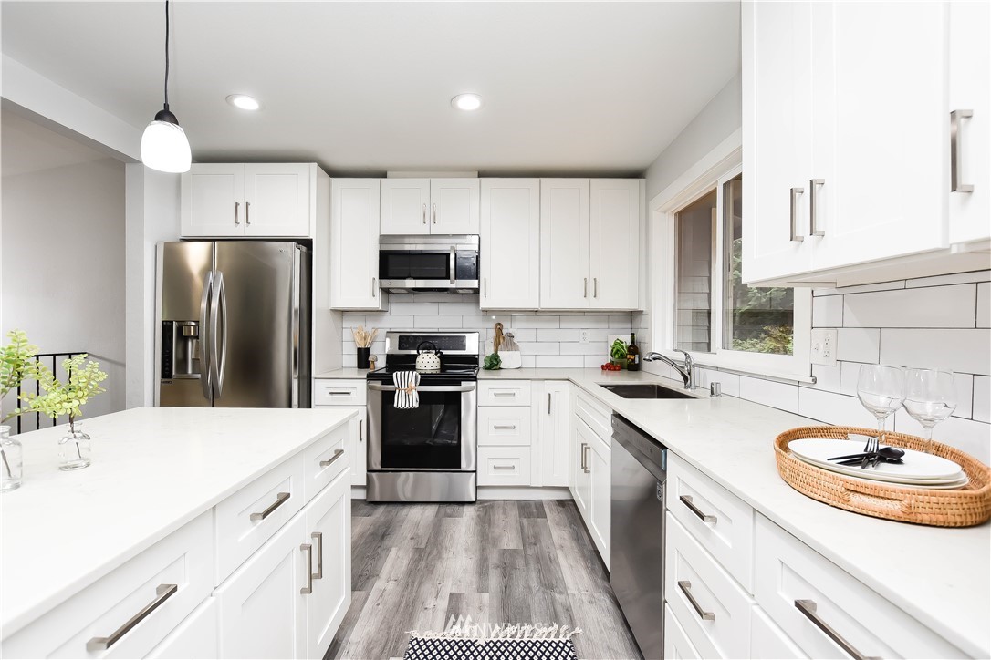 322 170th Place Southwest Bothell, WA 98012 - Photo 15 of 37 a kitchen with a sink a stove a refrigerator and a oven