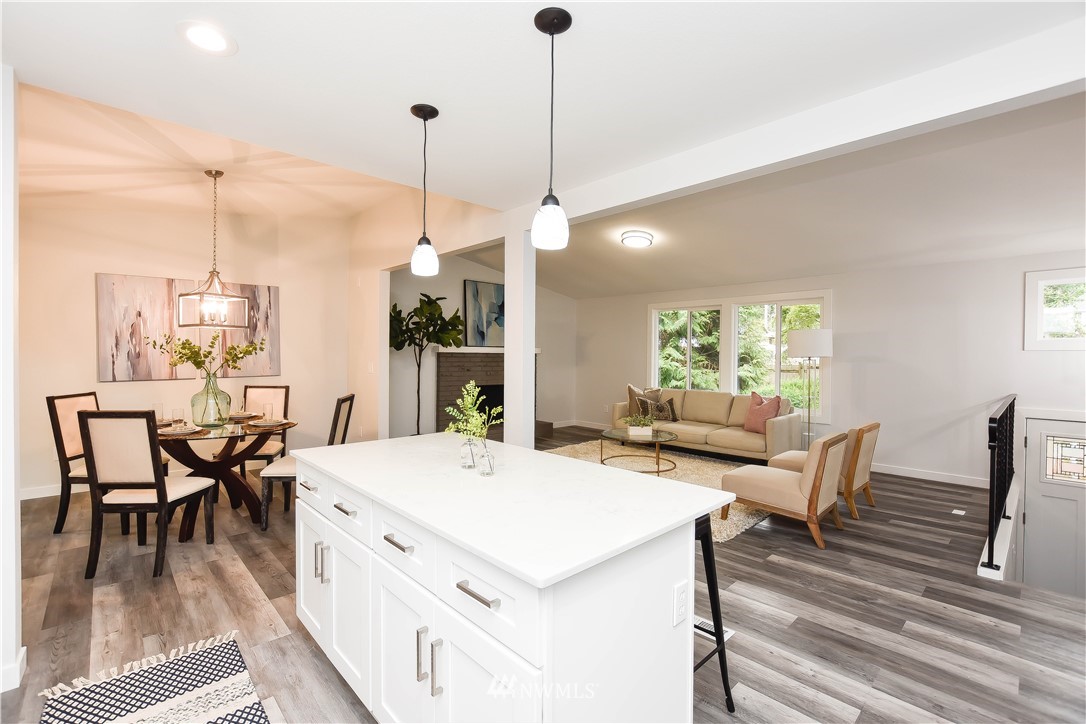 322 170th Place Southwest Bothell, WA 98012 - Photo 16 of 37 a view of a dining room and livingroom with furniture wooden floor a chandelier