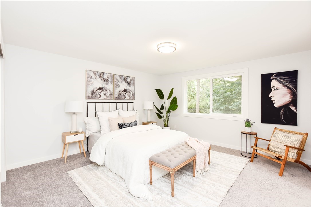 322 170th Place Southwest Bothell, WA 98012 - Photo 21 of 37 a bedroom with a bed and a large mirror on a dresser