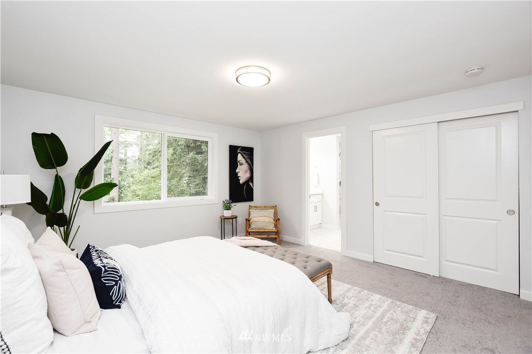 322 170th Place Southwest Bothell, WA 98012 - Photo 22 of 37 a bedroom with a large bed and a large window