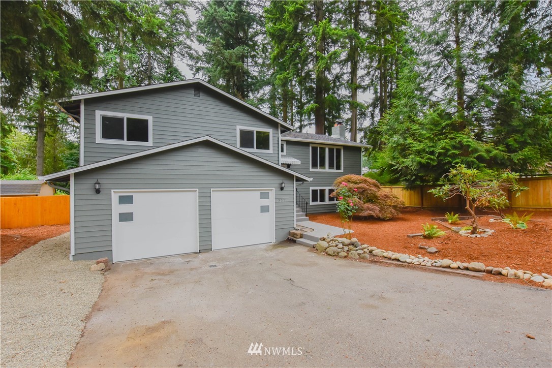 322 170th Place Southwest Bothell, WA 98012 - Photo 4 of 37 a view of a house with a yard and garage
