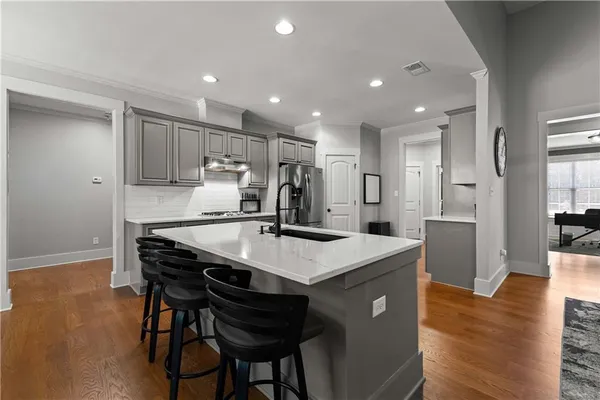 a kitchen with granite countertop stainless steel appliances a sink and counter space