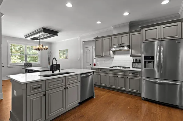 a kitchen with stainless steel appliances a sink stove and refrigerator