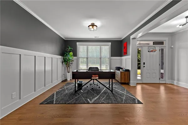 a view of a livingroom with wooden floor and a ceiling fan